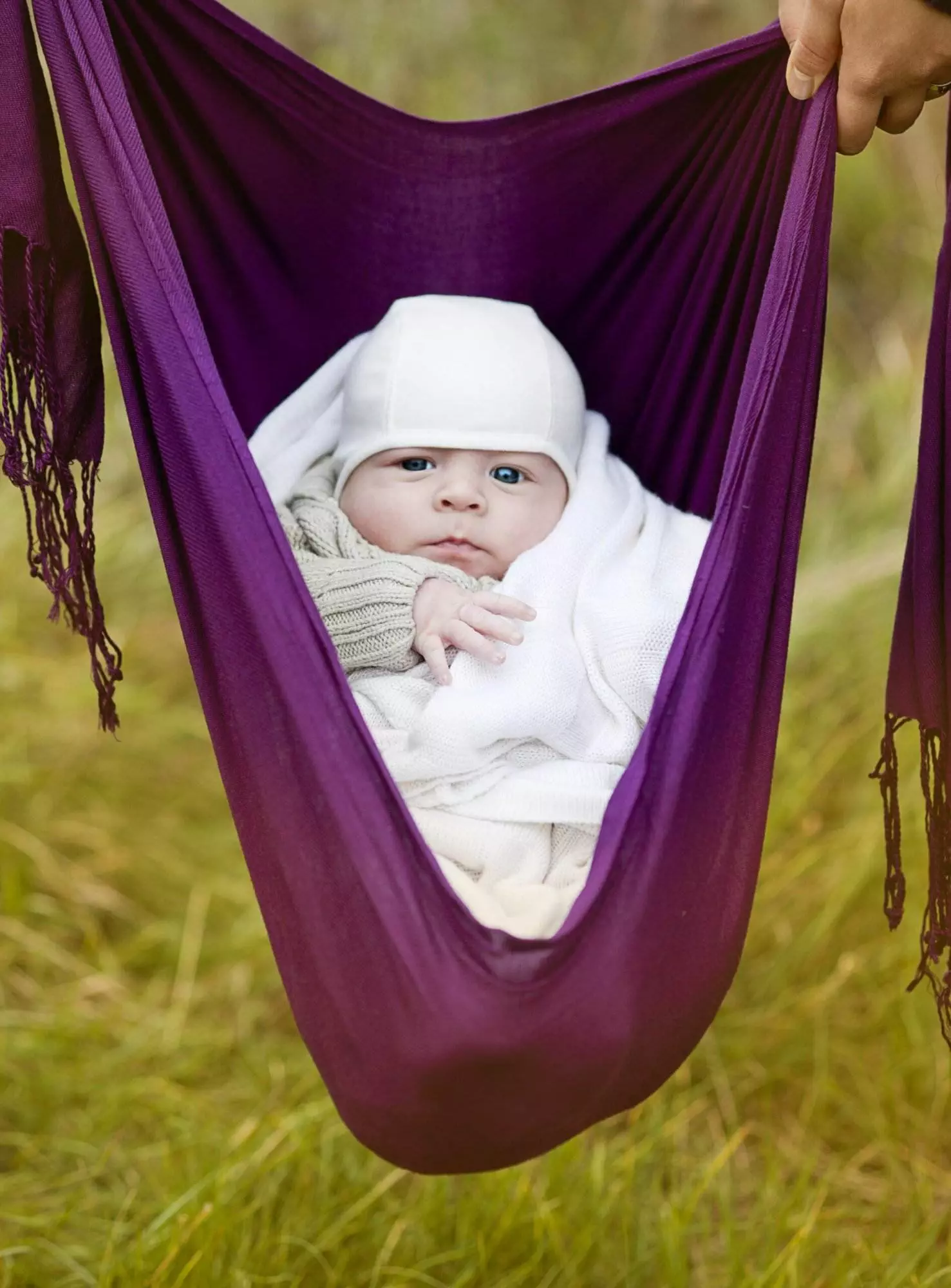 Baby in purple hammock outdoors