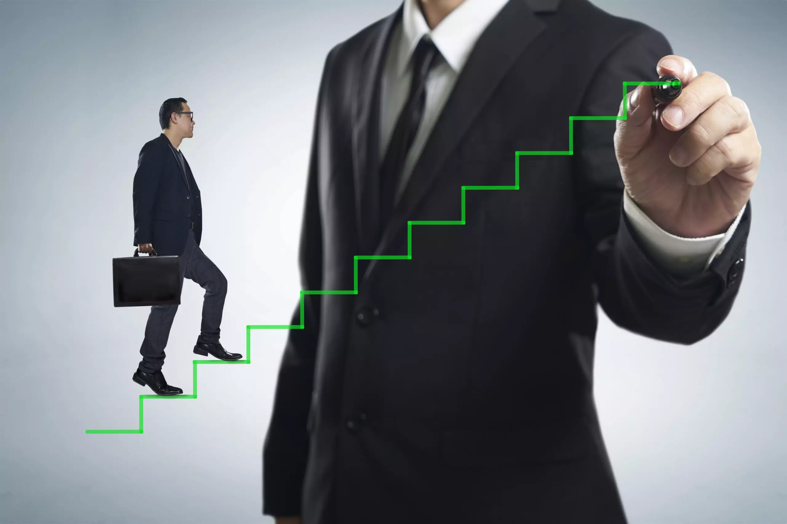 Man climbing drawn career growth chart stairs.