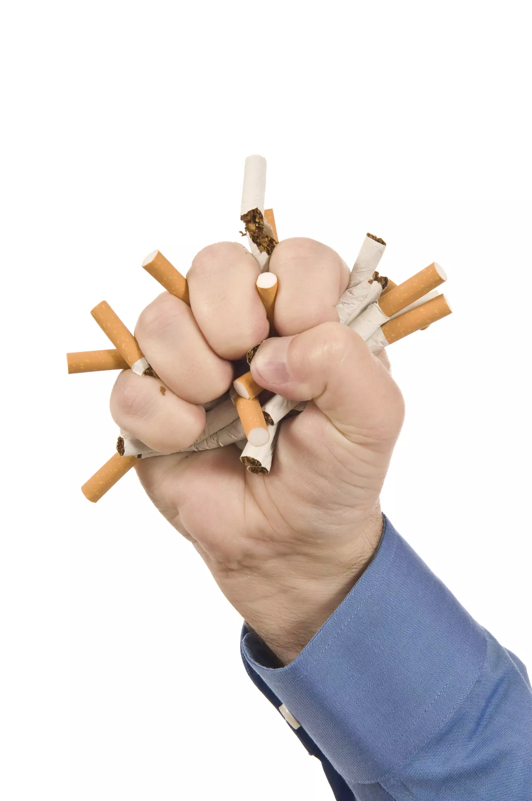 Hand crushing multiple cigarettes, quitting smoking concept.