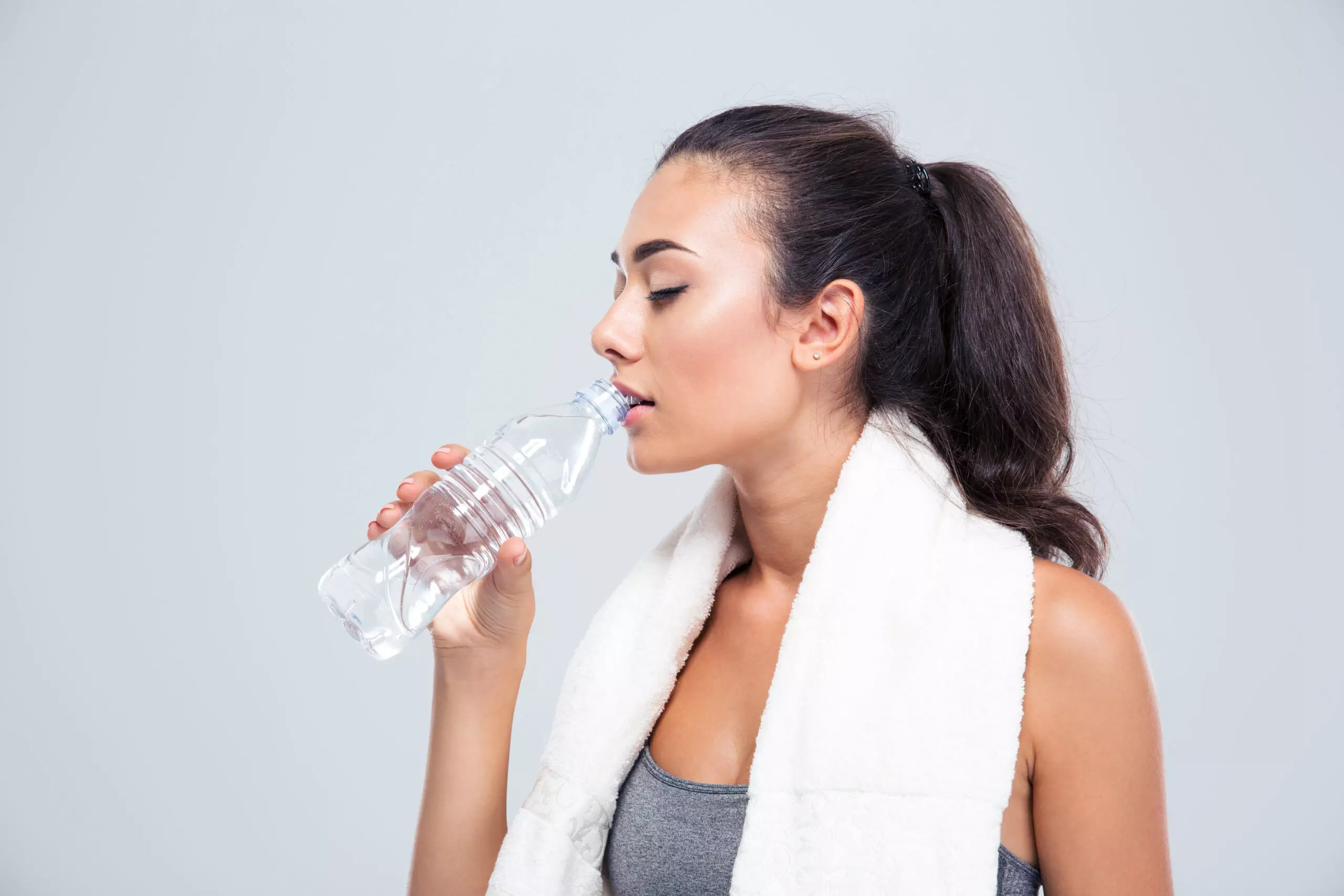 Woman drinking water after workout.